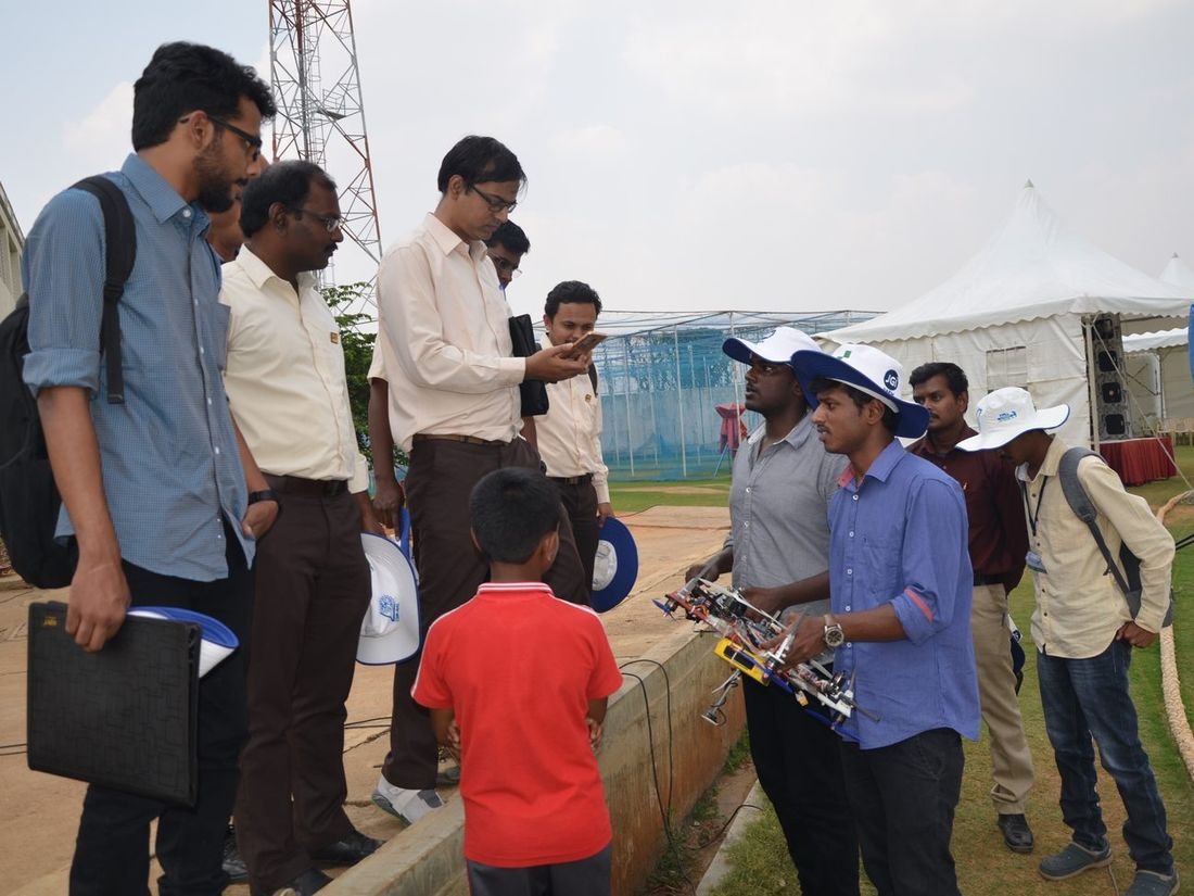 Alfa Drones engineers demonstrating a survey aircraft to officials and visitors at a field event