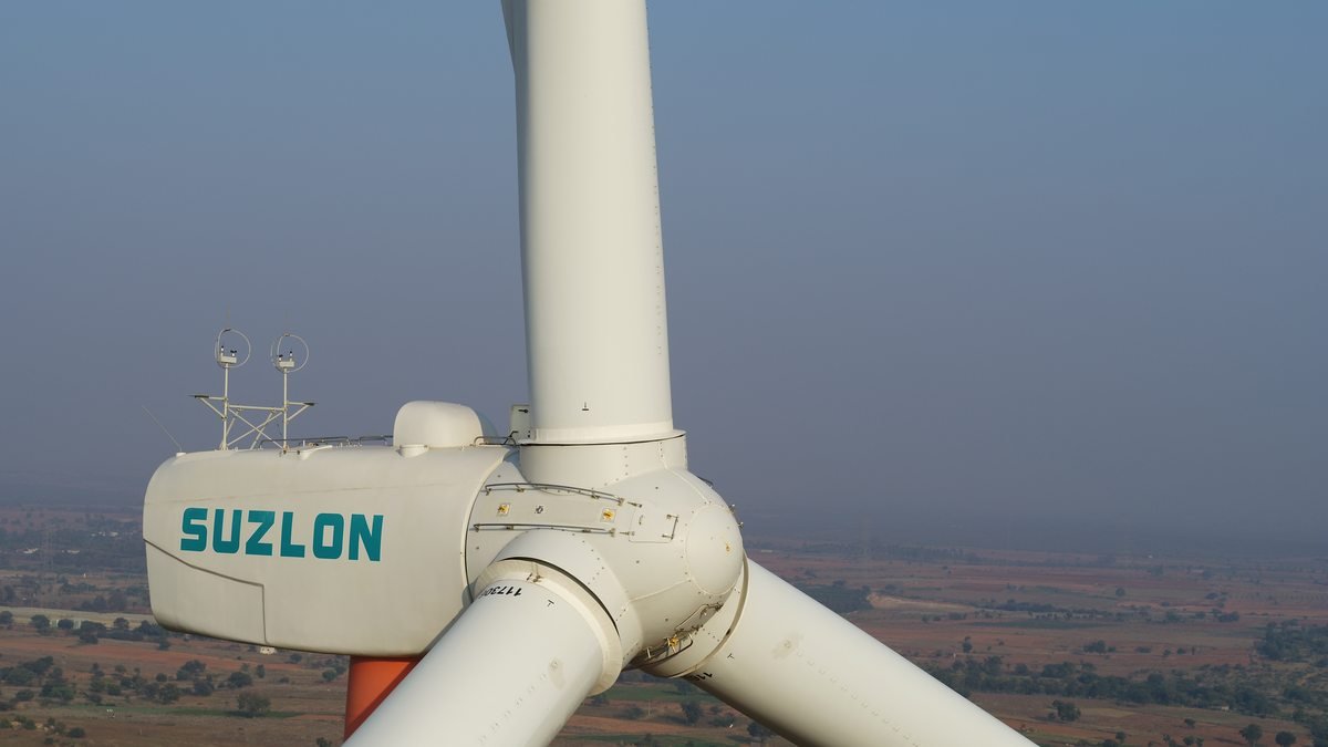 Close aerial view of a Suzlon turbine nacelle showing anemometers and rotor hub